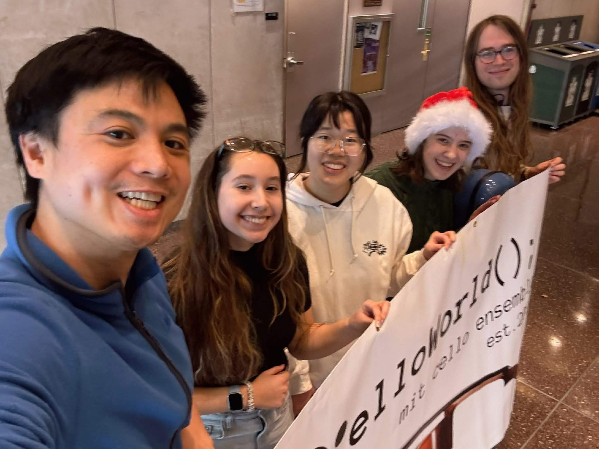 Celloworld members hold a banner after the Fall 2025 showcase.